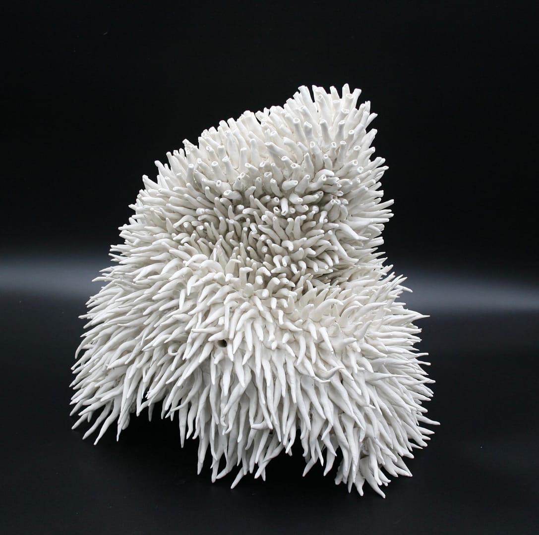 Clara Lundgrens porcelain sculpture with an undulating form covered in numerous thin, elongated spikes that evoke thoughts of underwater life.