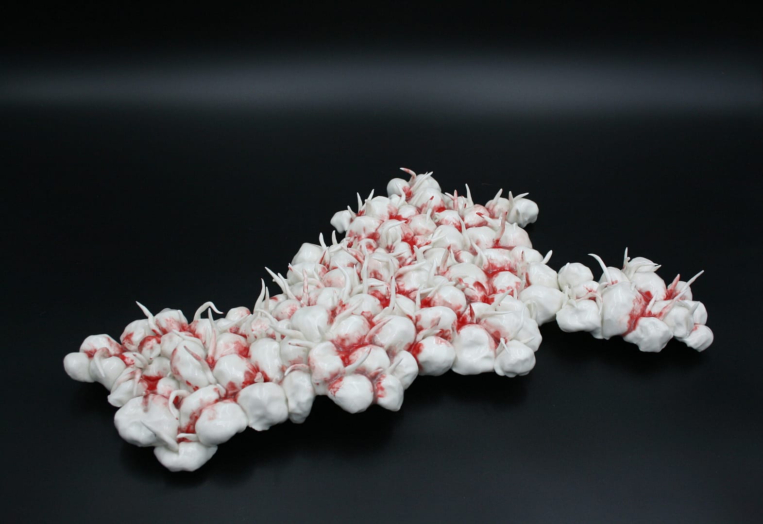 Clara Lundgrens porcelain sculpture presents a captivating surface composed of white bubbles